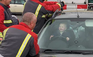 Toddler Can't Stop Laughing After Locking Himself In Car While 5 Firefighters Try To Rescue Him