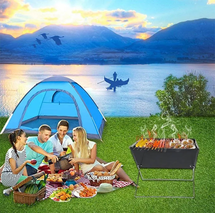 Group enjoying a picnic next to a tent with a barbecue, showcasing a humorous design fail of a boat on grass.
