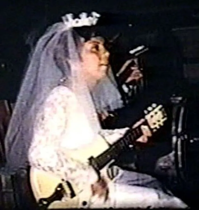 My Mother, Jeanette, Playing Guitar At Her Own Wedding In 1966.  She Said The Band Sucked So She And Her Band Played For The Crowd Instead. They Were Called Little Jeanie And The Caravan.