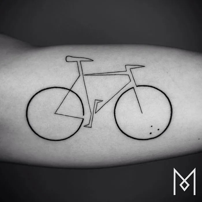 Single line tattoo of a bicycle by Mo Ganji on forearm, showcasing minimalistic tattoo art.