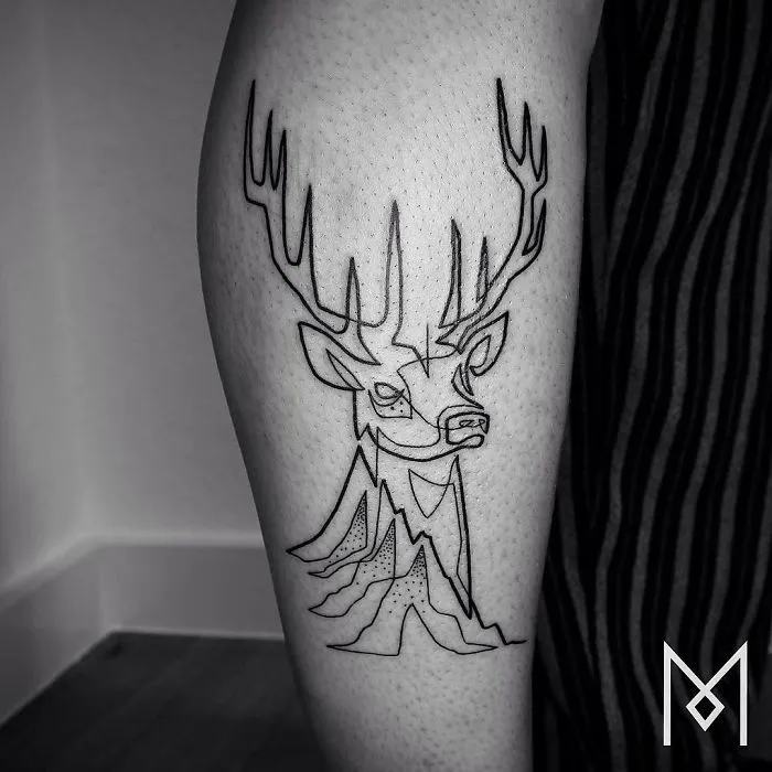 Single continuous line tattoo of a deer on a person's leg, by artist Mo Ganji.