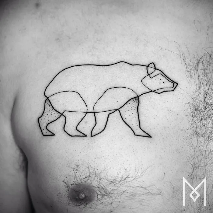 Single continuous line bear tattoo on a man's chest by Mo Ganji.