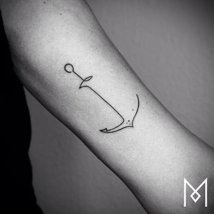Single continuous line tattoo of an anchor on an arm by Mo Ganji.