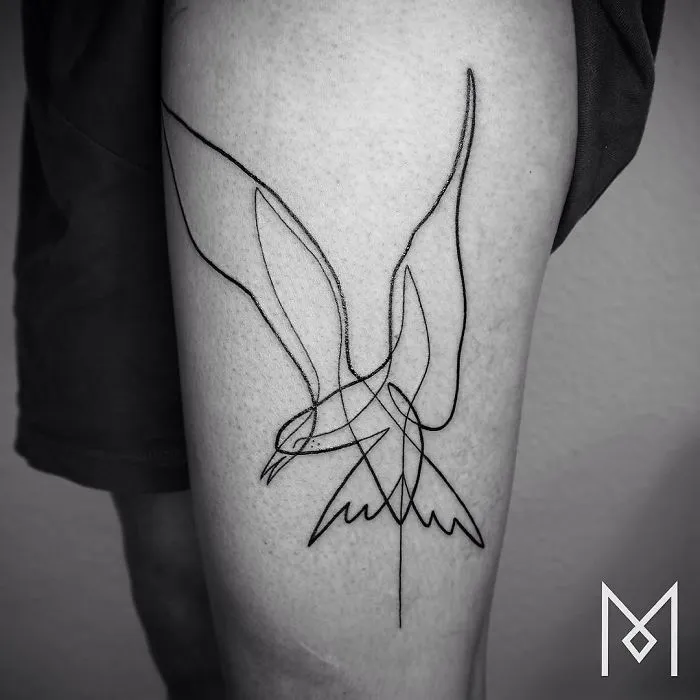 Single line bird tattoo by Mo Ganji on a person's leg, showcasing minimalist and unique ink art.