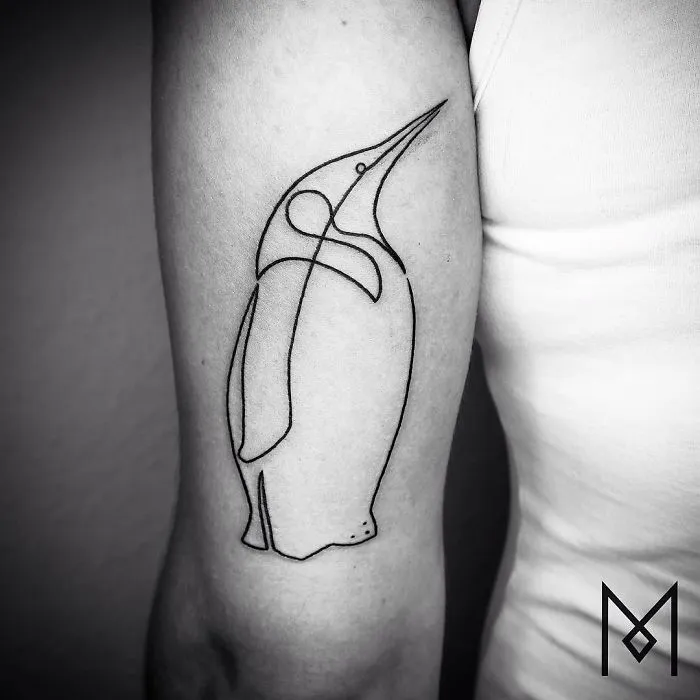 Single line tattoo of a penguin on an arm by Mo Ganji.