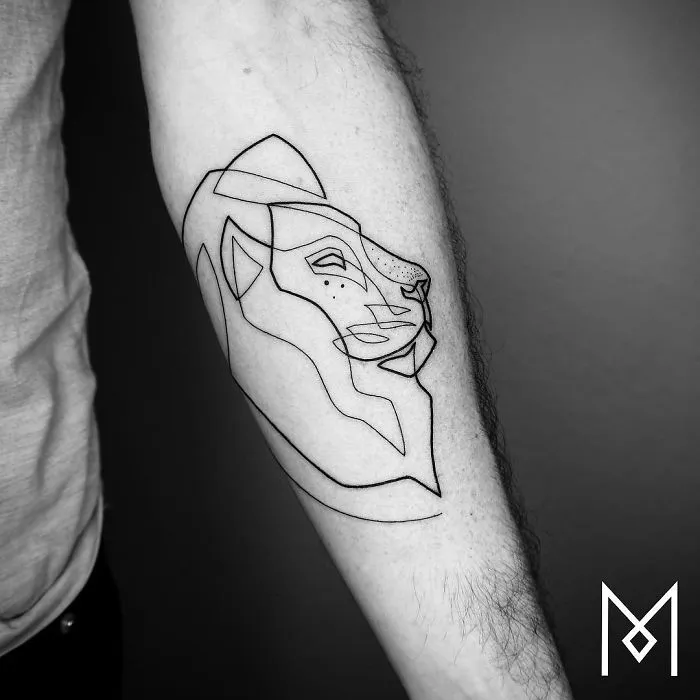 Minimalist lion tattoo using a single continuous line by artist Mo Ganji on forearm.