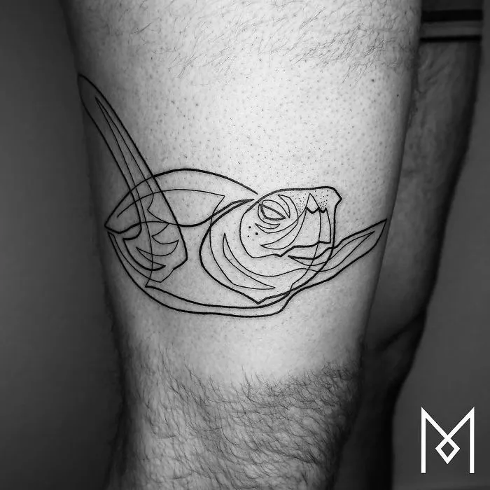 Single continuous line tattoo of a sea turtle by Mo Ganji on a person's leg.