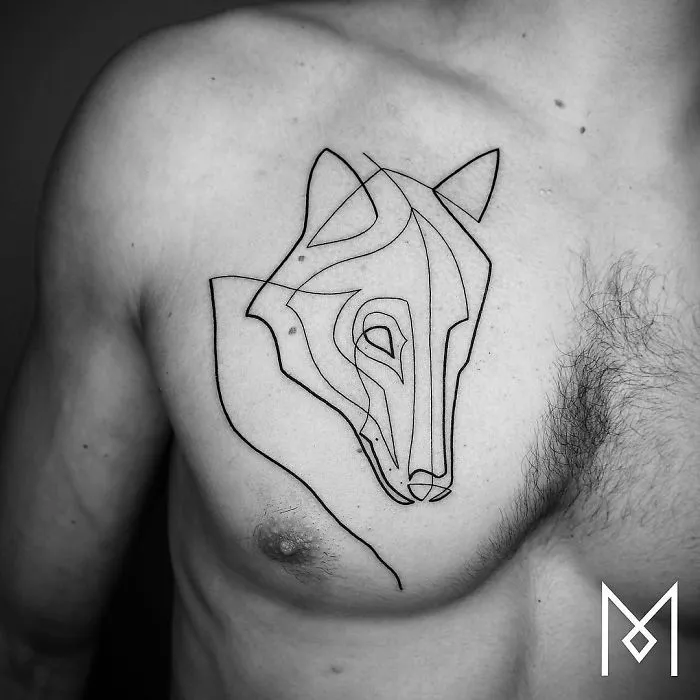 Single line tattoo of a wolf on a man's chest by Mo Ganji.