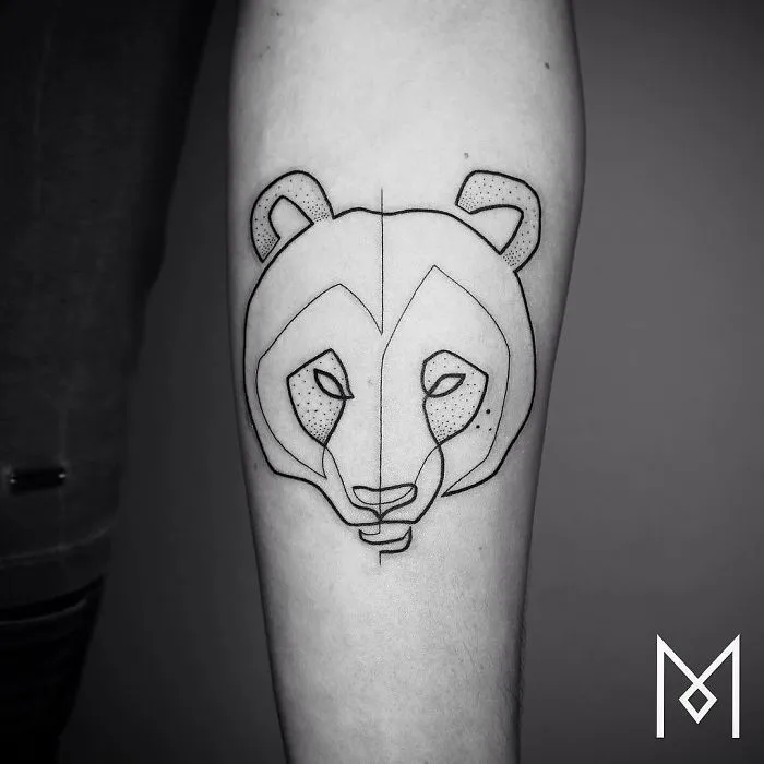 Single continuous line tattoo of an animal face by Mo Ganji on forearm.