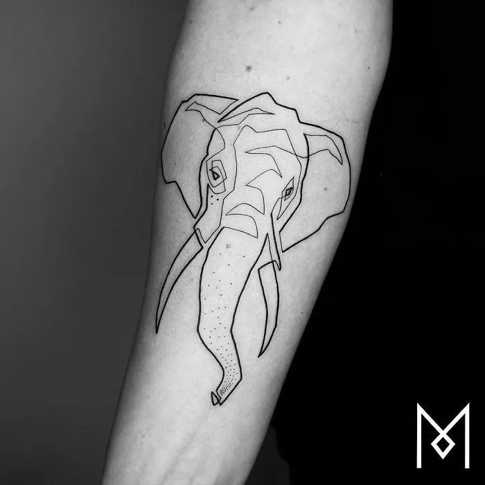 Single line tattoo of an elephant on an arm by Mo Ganji.