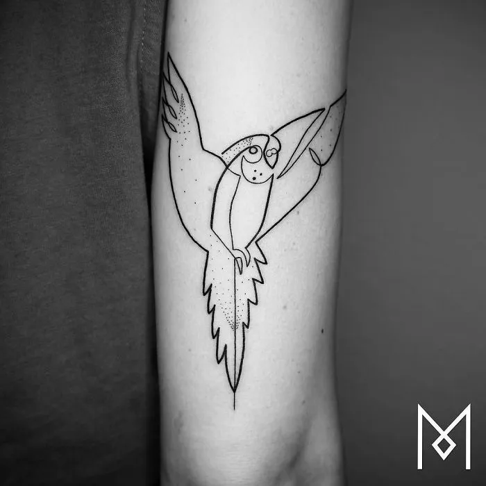 Single continuous line parrot tattoo on arm by Mo Ganji.