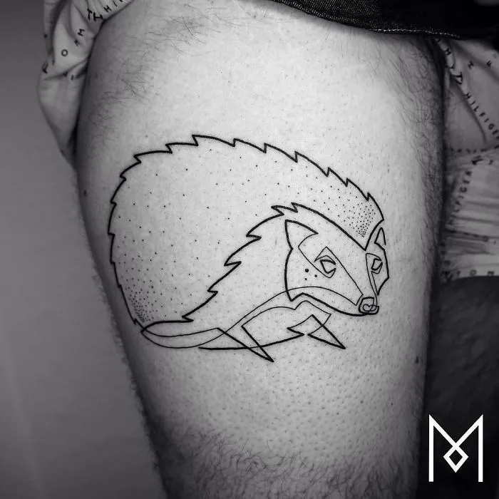 Single continuous line tattoo of a hedgehog on a thigh by Mo Ganji.