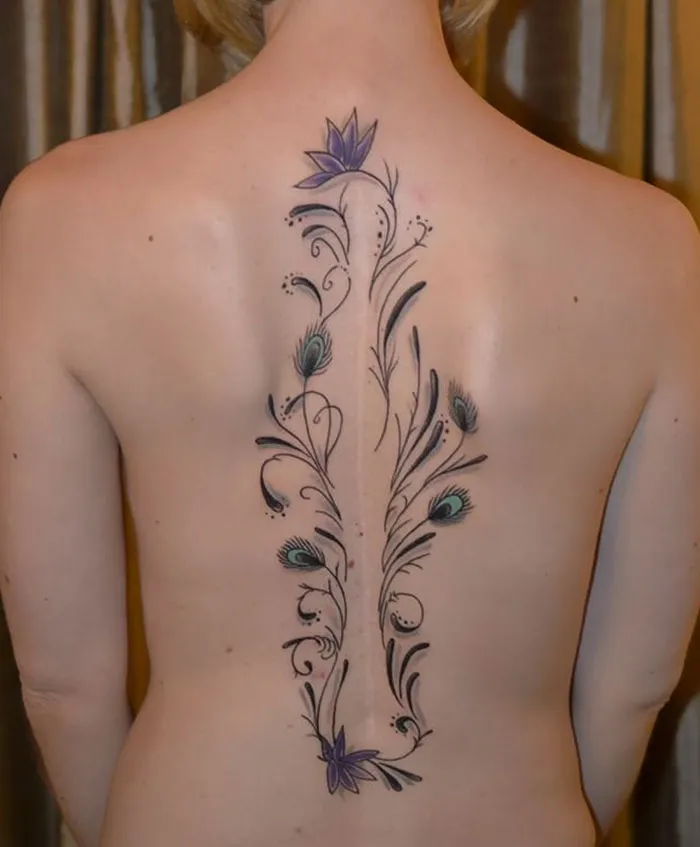 Floral tattoo beautifully transforms a back scar into art.