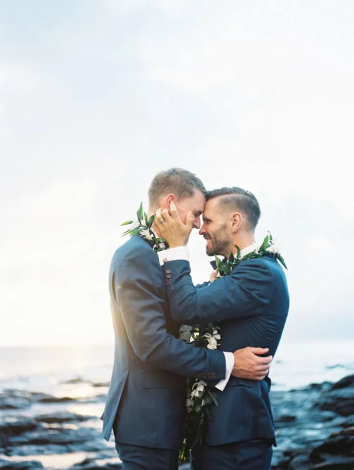 Two men hugging and looking each other in the eyes 