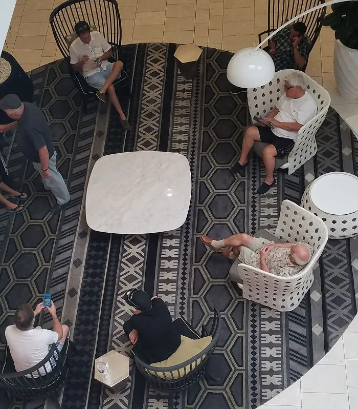 People relaxing on a patterned carpet in a mall, highlighting funny aspects of being married.