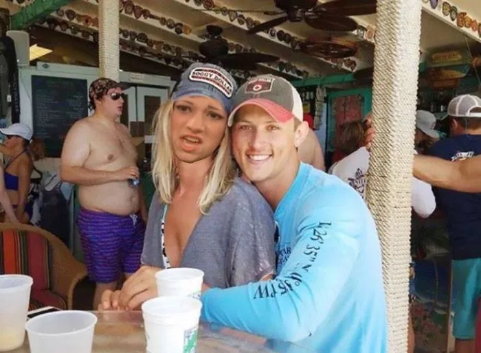 Couple Asks Internet To Photoshop Out Shirtless Guy From Engagement Photo, Regrets It Immediately