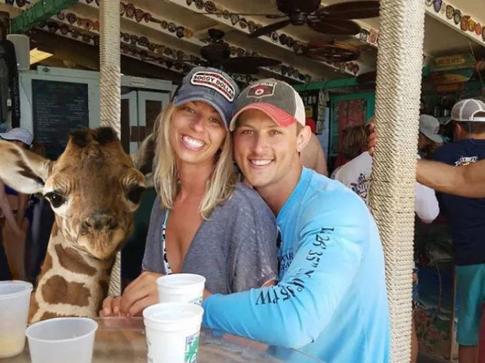 Couple Asks Internet To Photoshop Out Shirtless Guy From Engagement Photo, Regrets It Immediately