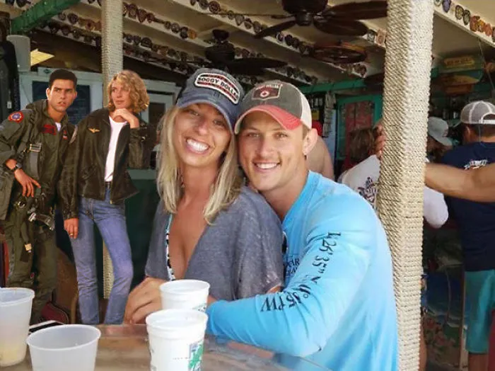 Couple Asks Internet To Photoshop Out Shirtless Guy From Engagement Photo, Regrets It Immediately