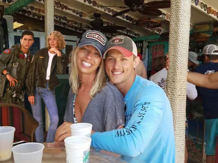 Couple Asks Internet To Photoshop Out Shirtless Guy From Engagement Photo, Regrets It Immediately
