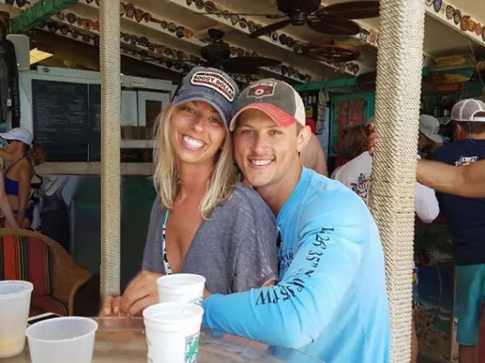 Couple Asks Internet To Photoshop Out Shirtless Guy From Engagement Photo, Regrets It Immediately