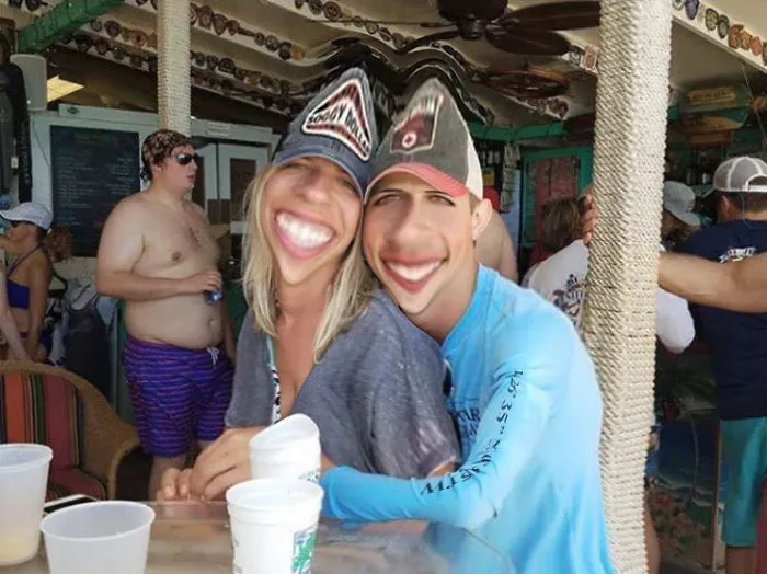 Couple Asks Internet To Photoshop Out Shirtless Guy From Engagement Photo, Regrets It Immediately