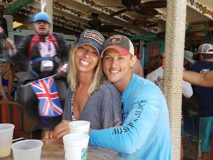 Couple Asks Internet To Photoshop Out Shirtless Guy From Engagement Photo, Regrets It Immediately
