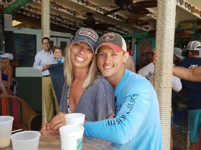 Couple Asks Internet To Photoshop Out Shirtless Guy From Engagement Photo, Regrets It Immediately