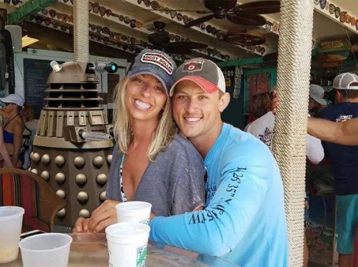 Couple Asks Internet To Photoshop Out Shirtless Guy From Engagement Photo, Regrets It Immediately