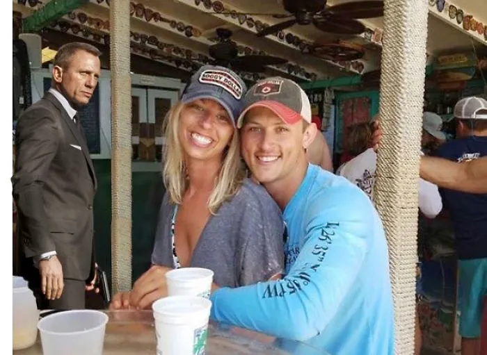 Couple Asks Internet To Photoshop Out Shirtless Guy From Engagement Photo, Regrets It Immediately