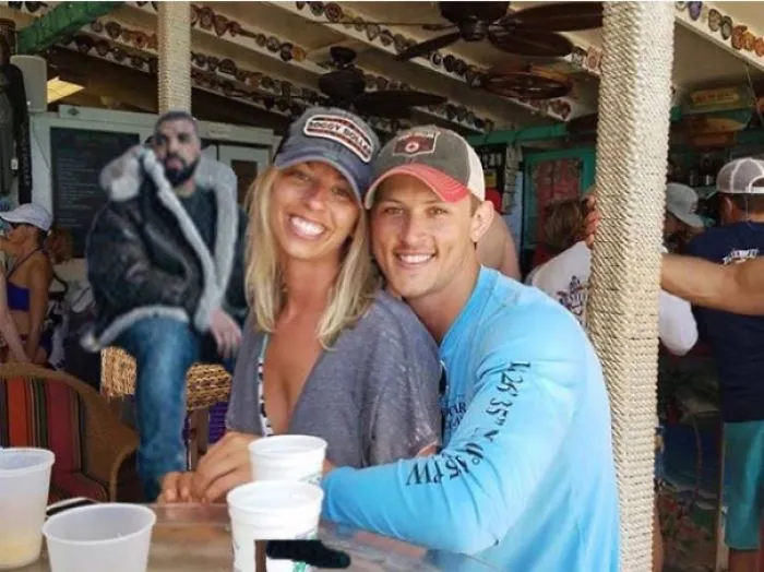 Couple Asks Internet To Photoshop Out Shirtless Guy From Engagement Photo, Regrets It Immediately