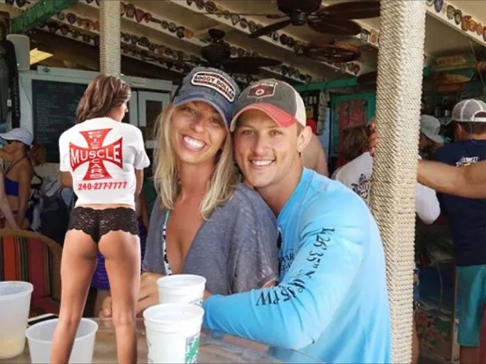 Couple Asks Internet To Photoshop Out Shirtless Guy From Engagement Photo, Regrets It Immediately