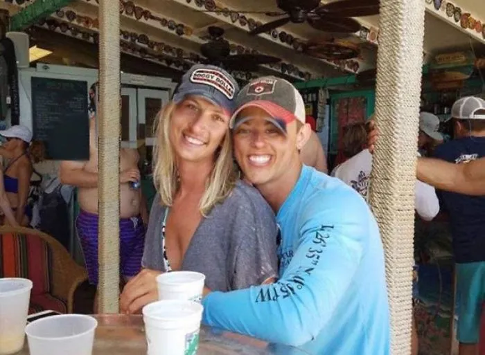 Couple Asks Internet To Photoshop Out Shirtless Guy From Engagement Photo, Regrets It Immediately