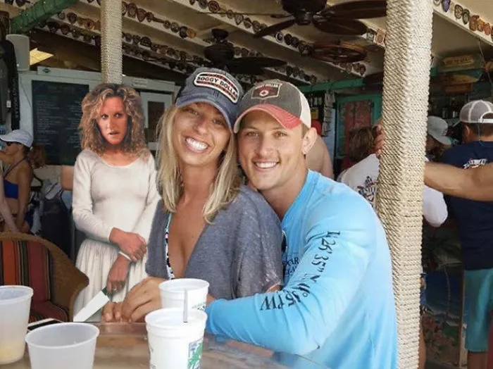 Couple Asks Internet To Photoshop Out Shirtless Guy From Engagement Photo, Regrets It Immediately