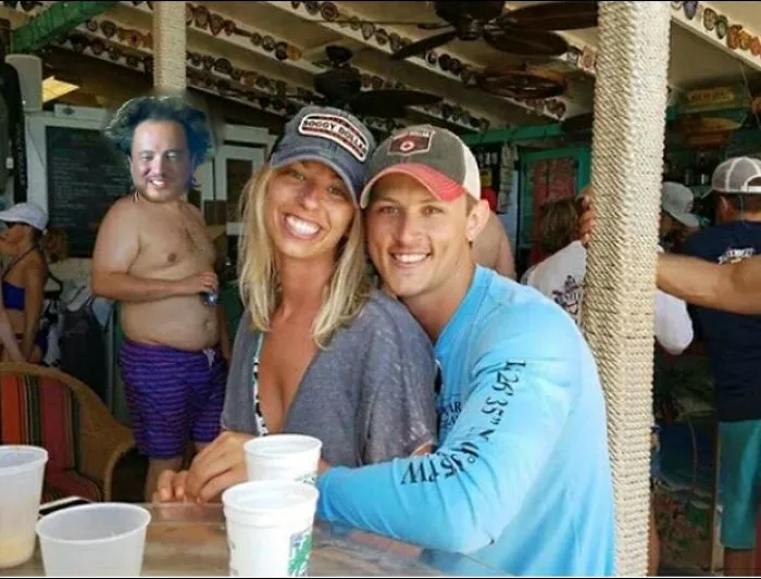 Couple Asks Internet To Photoshop Out Shirtless Guy From Engagement Photo, Regrets It Immediately