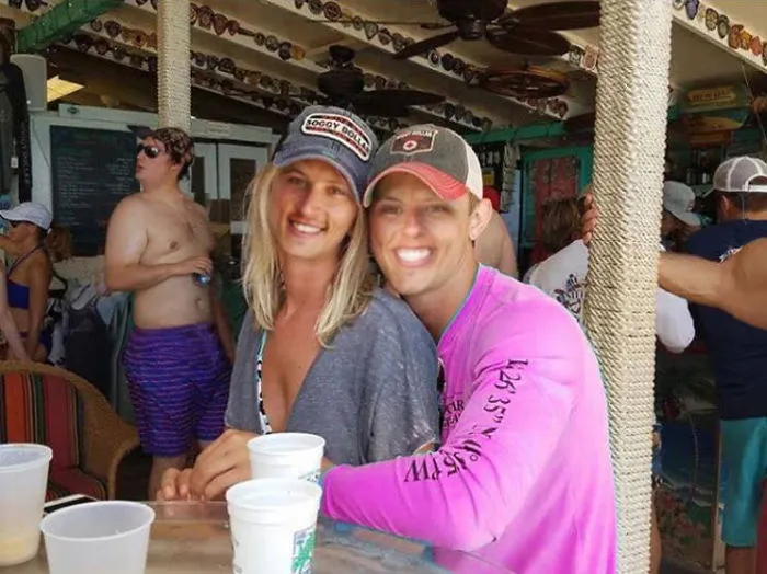 Couple Asks Internet To Photoshop Out Shirtless Guy From Engagement Photo, Regrets It Immediately