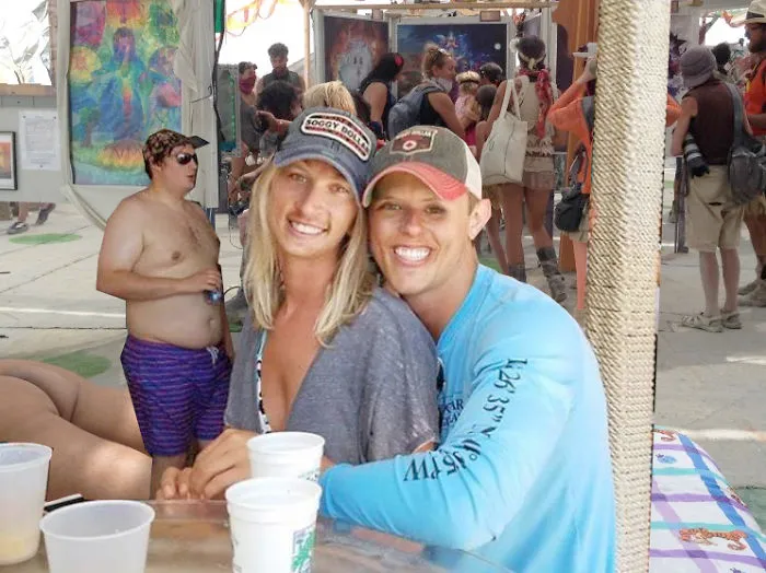 Couple Asks Internet To Photoshop Out Shirtless Guy From Engagement Photo, Regrets It Immediately