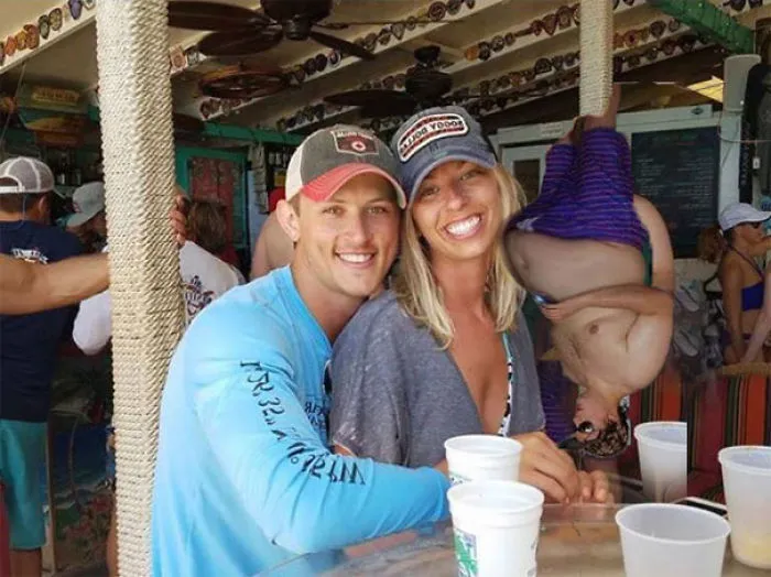 Couple Asks Internet To Photoshop Out Shirtless Guy From Engagement Photo, Regrets It Immediately