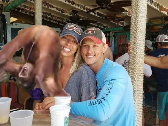 Couple Asks Internet To Photoshop Out Shirtless Guy From Engagement Photo, Regrets It Immediately