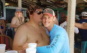 Couple Asks Internet To Photoshop Out Shirtless Guy From Engagement Photo, Regrets It Immediately