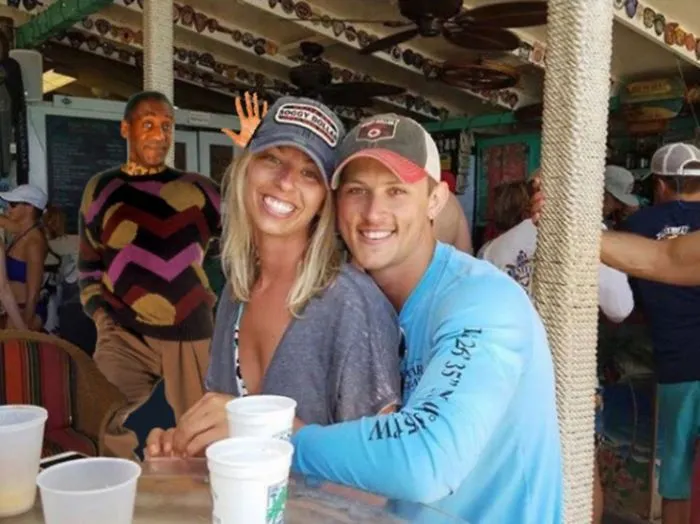 Couple Asks Internet To Photoshop Out Shirtless Guy From Engagement Photo, Regrets It Immediately