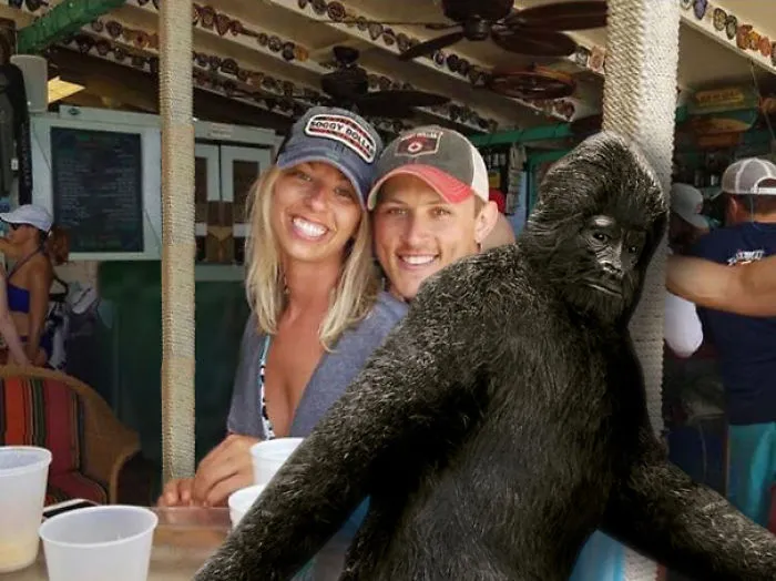 Couple Asks Internet To Photoshop Out Shirtless Guy From Engagement Photo, Regrets It Immediately