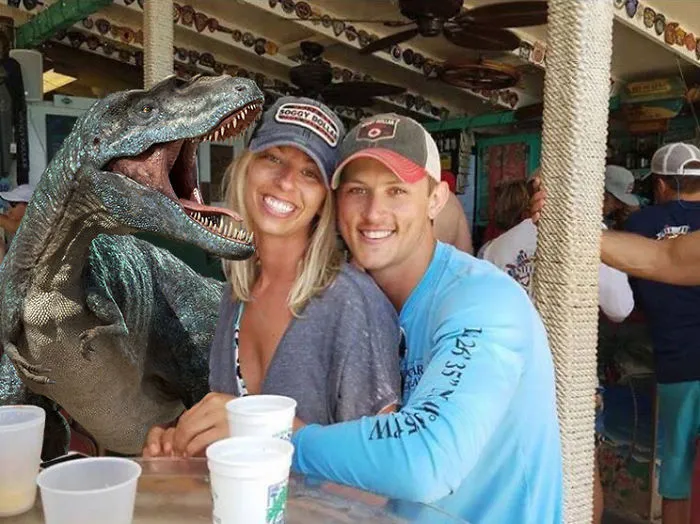 Couple Asks Internet To Photoshop Out Shirtless Guy From Engagement Photo, Regrets It Immediately