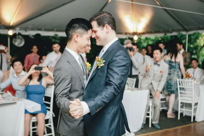Two men dancing and looking at each other eyes 