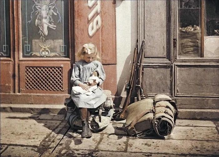A Girl Holds A Doll Next To Soldiers' Equipment In Reims, France, 1917
