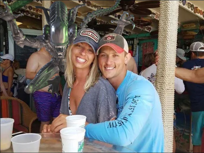 Couple Asks Internet To Photoshop Out Shirtless Guy From Engagement Photo, Regrets It Immediately