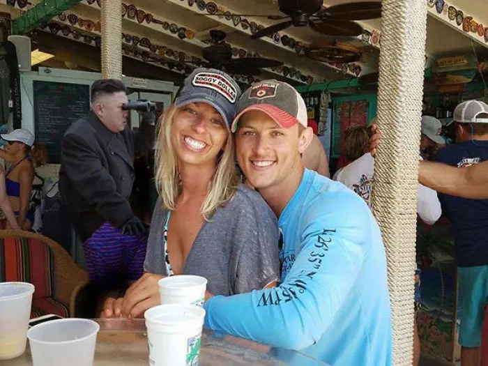 Couple Asks Internet To Photoshop Out Shirtless Guy From Engagement Photo, Regrets It Immediately