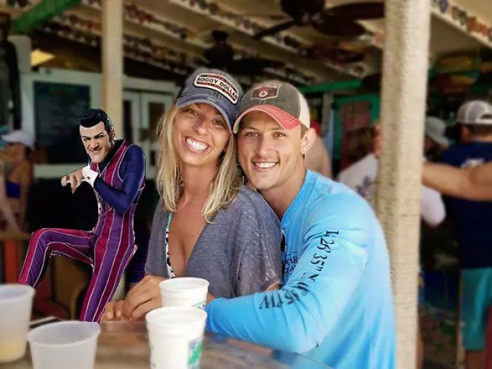 Couple Asks Internet To Photoshop Out Shirtless Guy From Engagement Photo, Regrets It Immediately