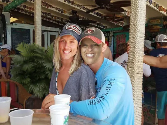 Couple Asks Internet To Photoshop Out Shirtless Guy From Engagement Photo, Regrets It Immediately