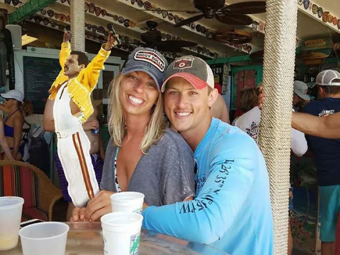 Couple Asks Internet To Photoshop Out Shirtless Guy From Engagement Photo, Regrets It Immediately