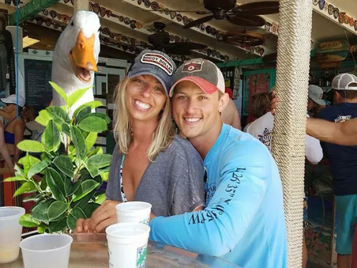 Couple Asks Internet To Photoshop Out Shirtless Guy From Engagement Photo, Regrets It Immediately
